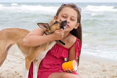 Girl with Dog on the Beach