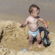 Baby in hole in sand | Sunset Vacations