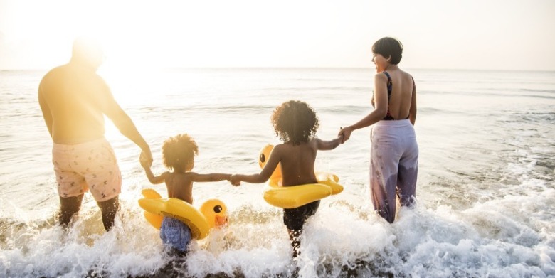 family together on the beach | Sunset Vacations