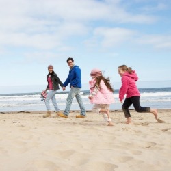 family on sunset beach | Sunset Vacations