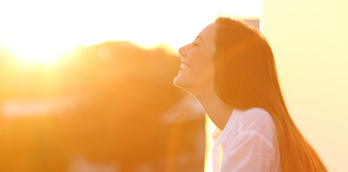 woman enjoying sunshine | Sunset Vacations